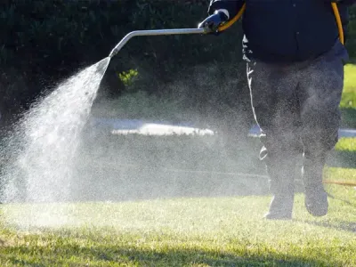 weed control, technician spraying grass