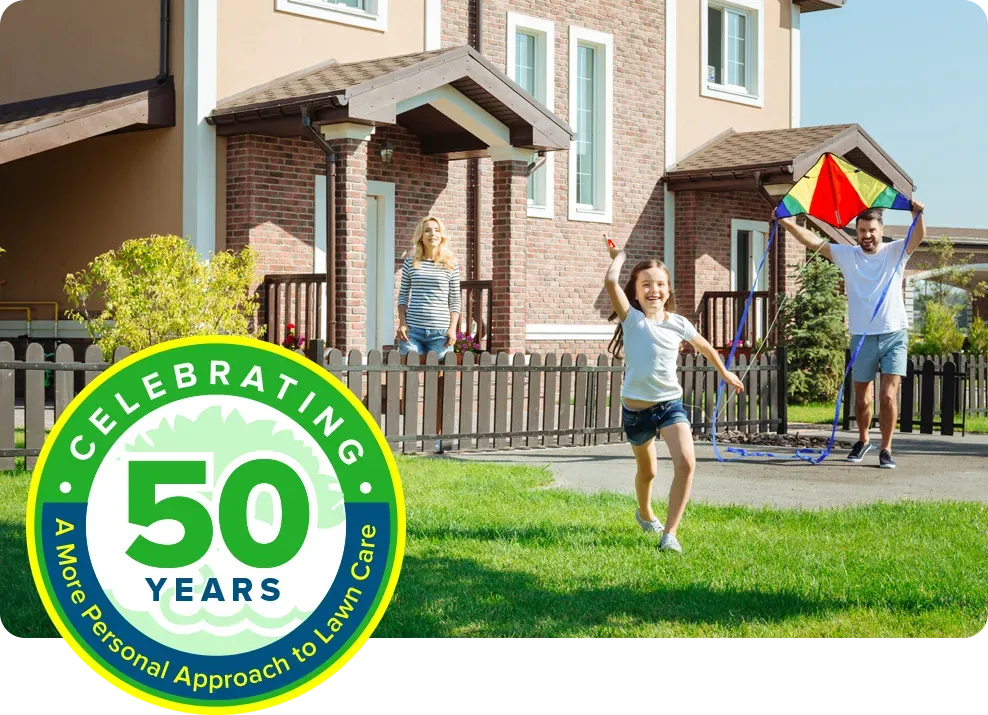 family playing outside on green healthy grass