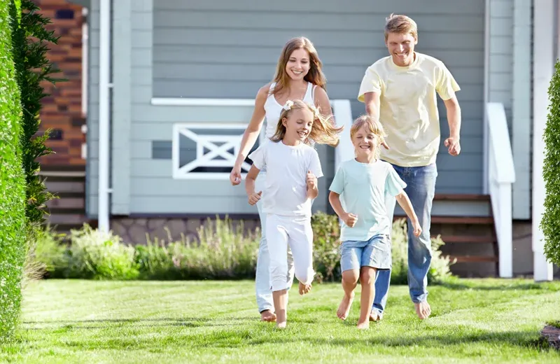 family running outside on green healthy grass